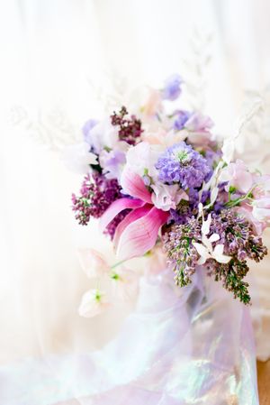 pink, purple, and white wedding bouquet with magnolias, sweet peas, and lilacs