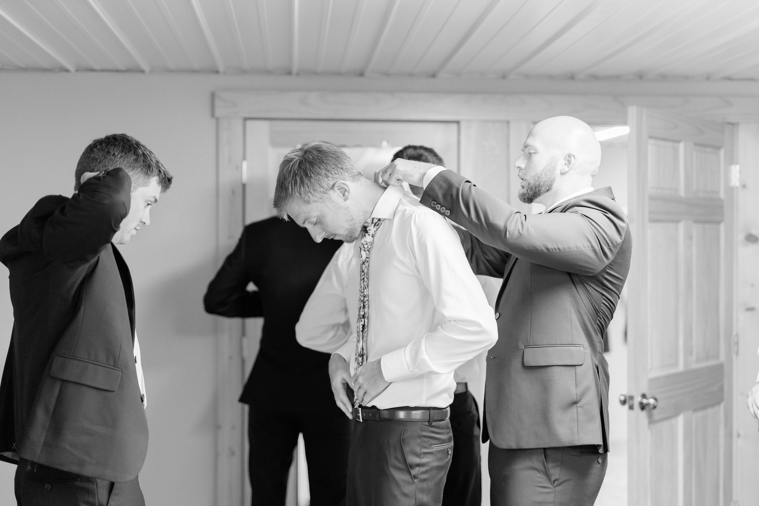 Groom getting ready photos in at Prairie Moon Winery wedding in Ames, Iowa