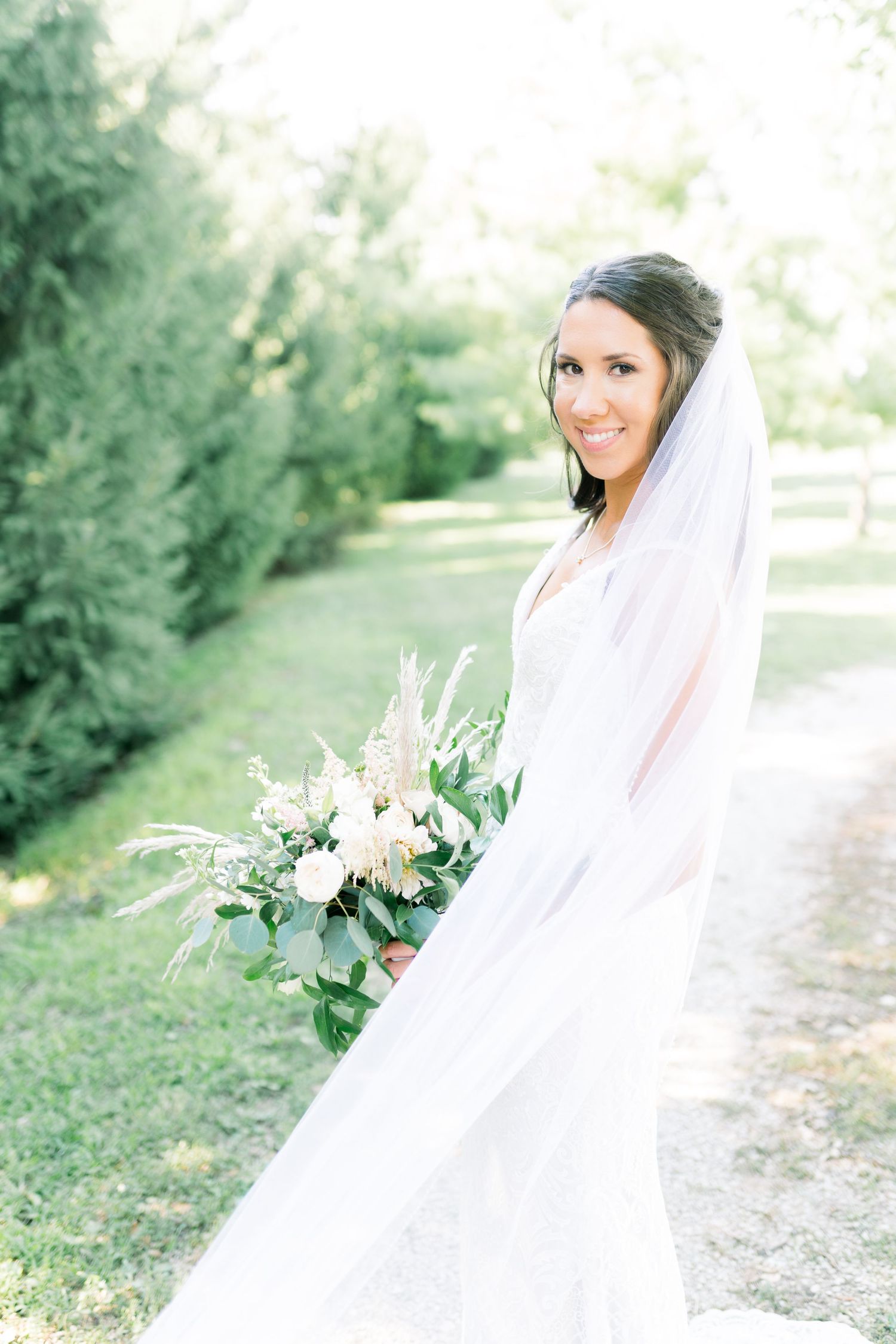 Veil wedding photos at Prairie Moon Winery in Ames, Iowa with White Willow boho florals