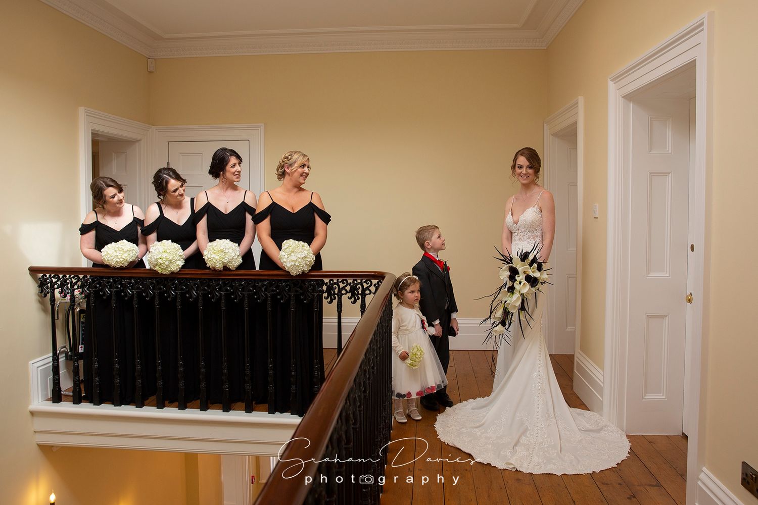 bride and her bridesmaids on the landing of St Tewdrics House