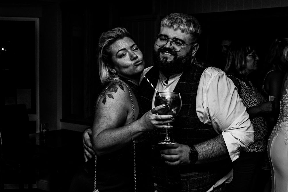 Black and white photo of guests having fun at wedding in Wales