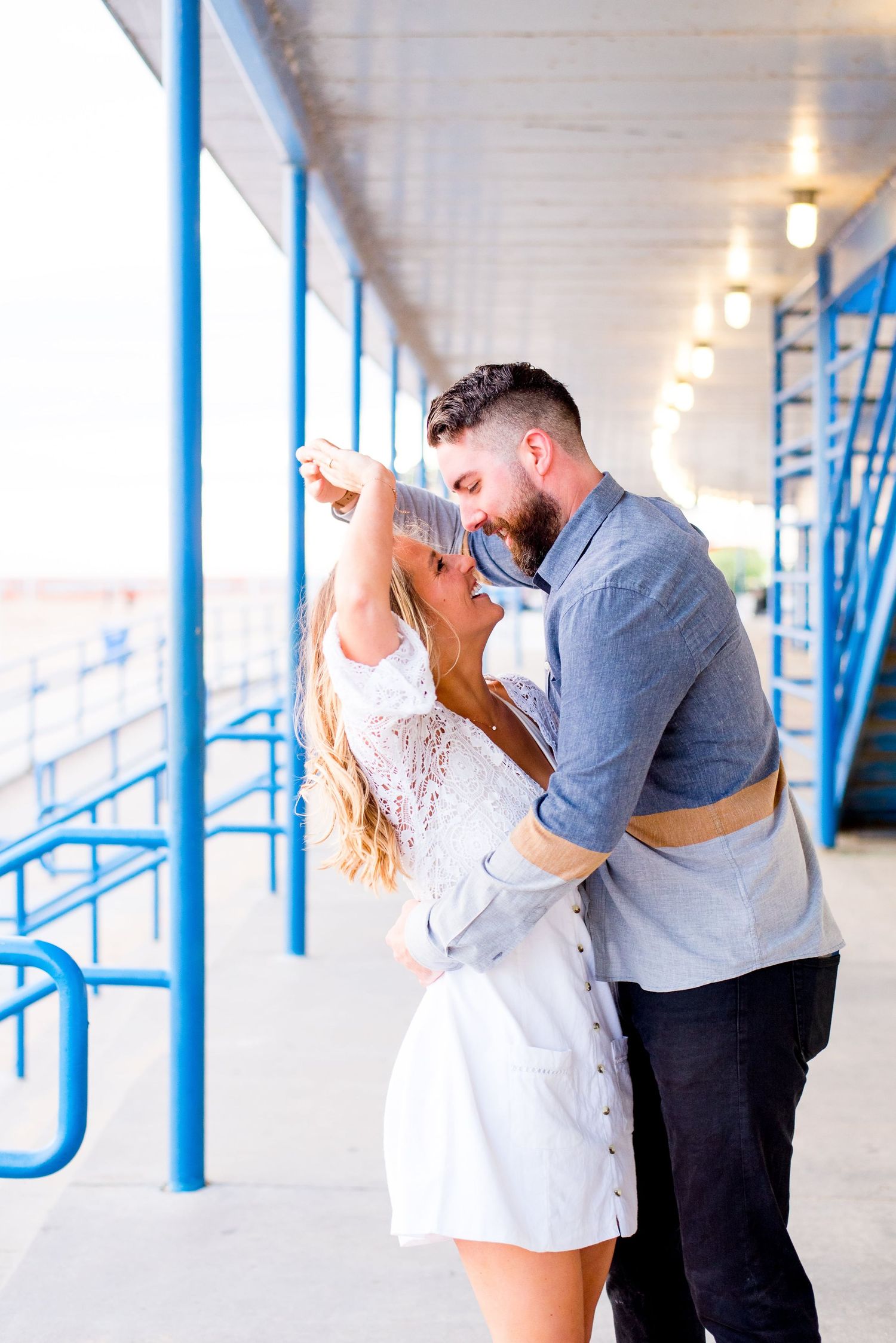 engaged couple spin and hug at North Avenue Beach