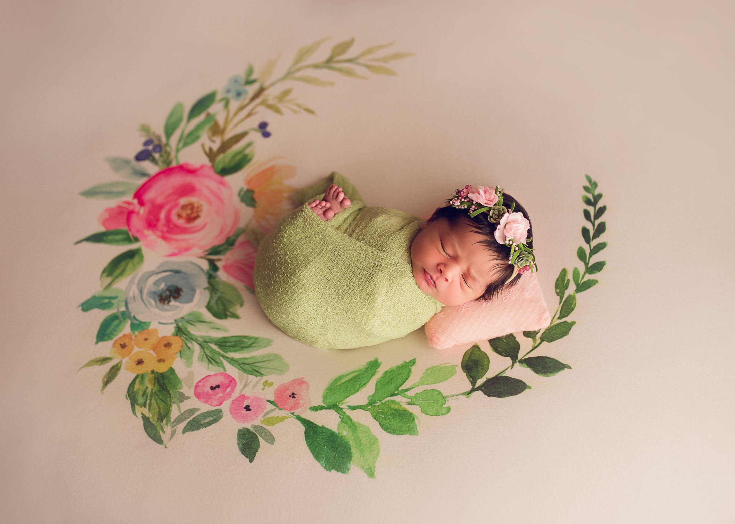 floral backdrop newborn baby wrapped in green