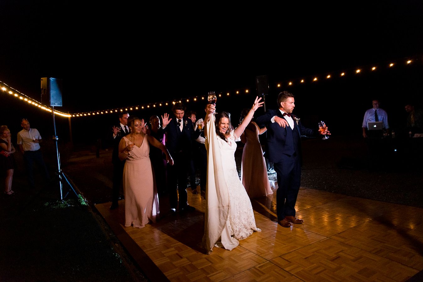 bride and groom dance with hands in air at Pennyroyal Farm wedding