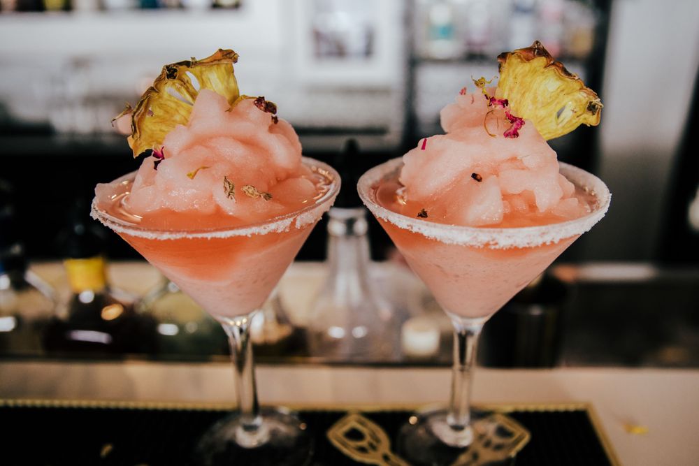 guava cocktails with dried pineapple garnish