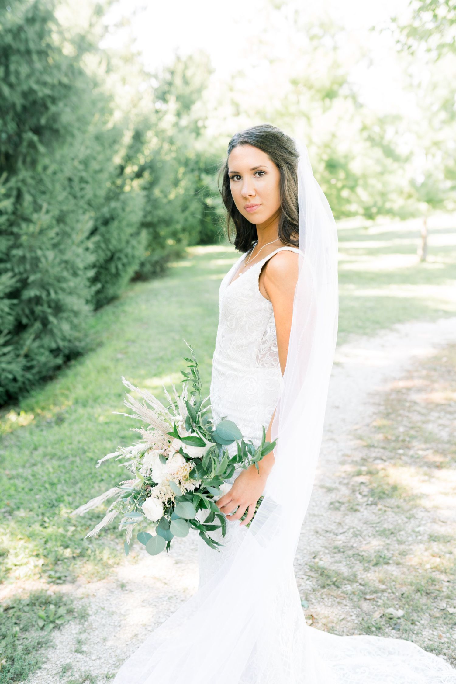 Veil wedding photos at Prairie Moon Winery in Ames, Iowa with White Willow boho florals