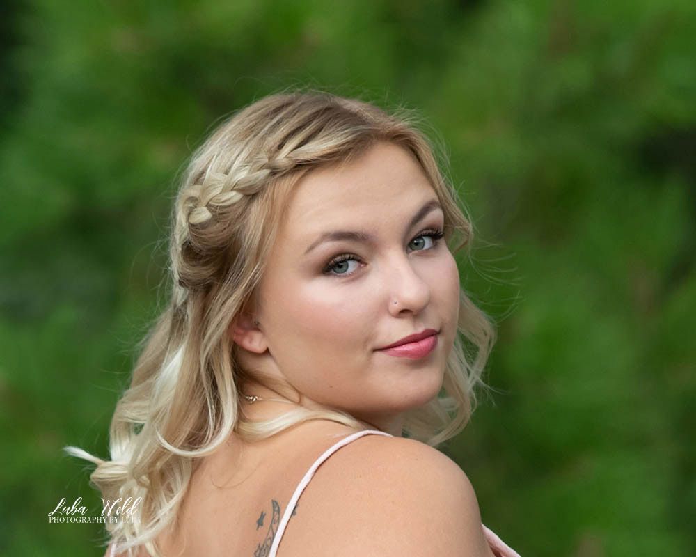 Spokane high school senior portrait of a girl with a braid in her hair and a tattoo on a blurred background professional