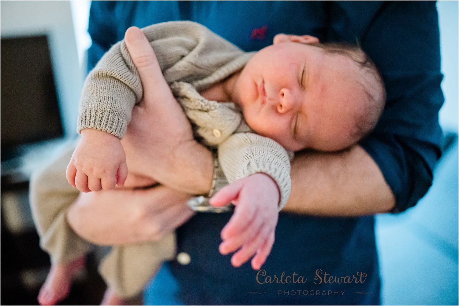 Father holding baby with hands on his chest in Vienna 5th district