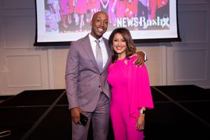 News Anchors together at event with Bash branding backdrop.