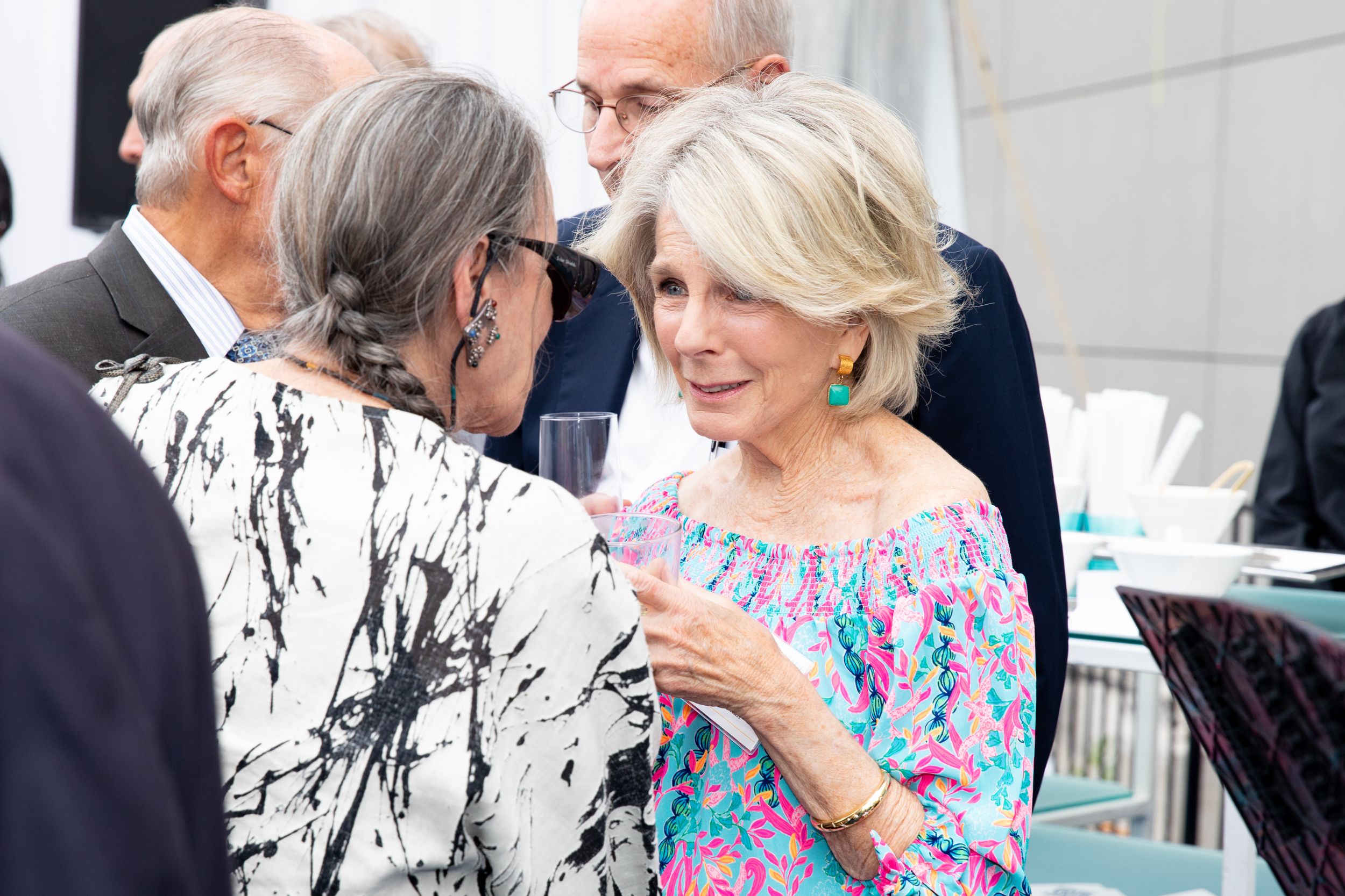 Guests chat and mingle during an elegant social gathering.