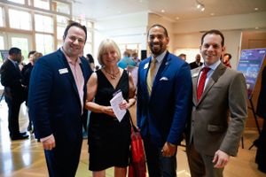 Group of attendees posing together at formal fundraising event.