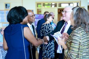 Group of people engaged in animated conversation at a professional networking event.