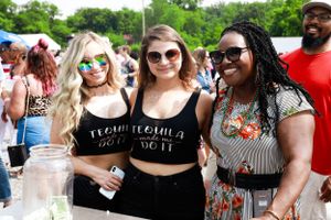 Group of friends enjoying themselves at a summer festival wearing casual attire.