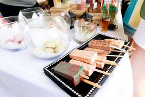 Elegant appetizers and snacks arranged on a white tablecloth at a catering event.