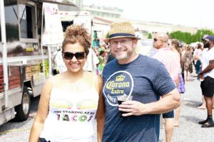 Festival attendees enjoying outdoor food and drink offerings on a sunny day.