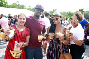 Group enjoying drinks together at an outdoor summer festival.