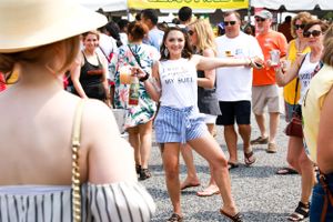 Festival-goer dances in the crowd at an outdoor summer event.