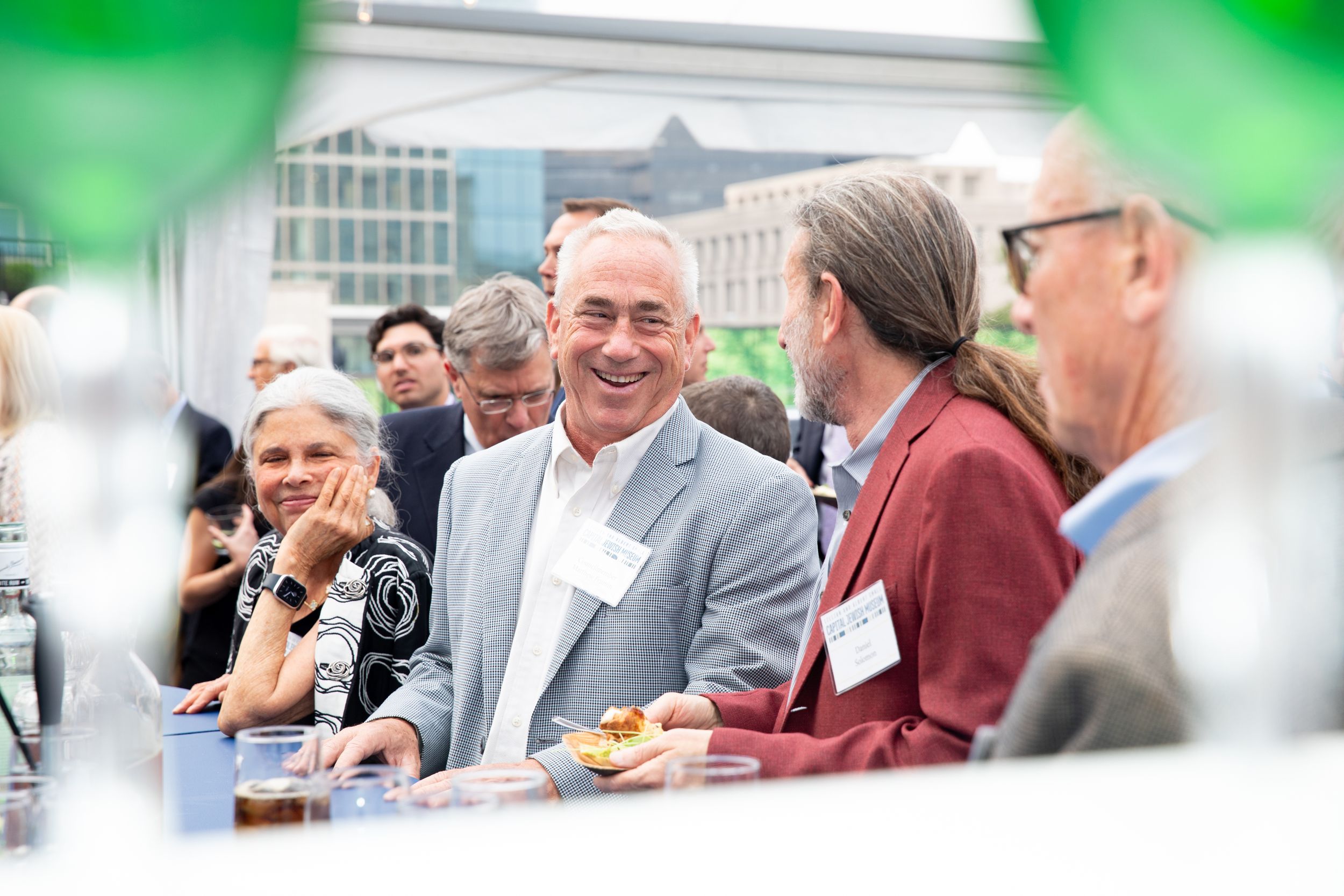Event guests share laughs and conversations during a catered social gathering.