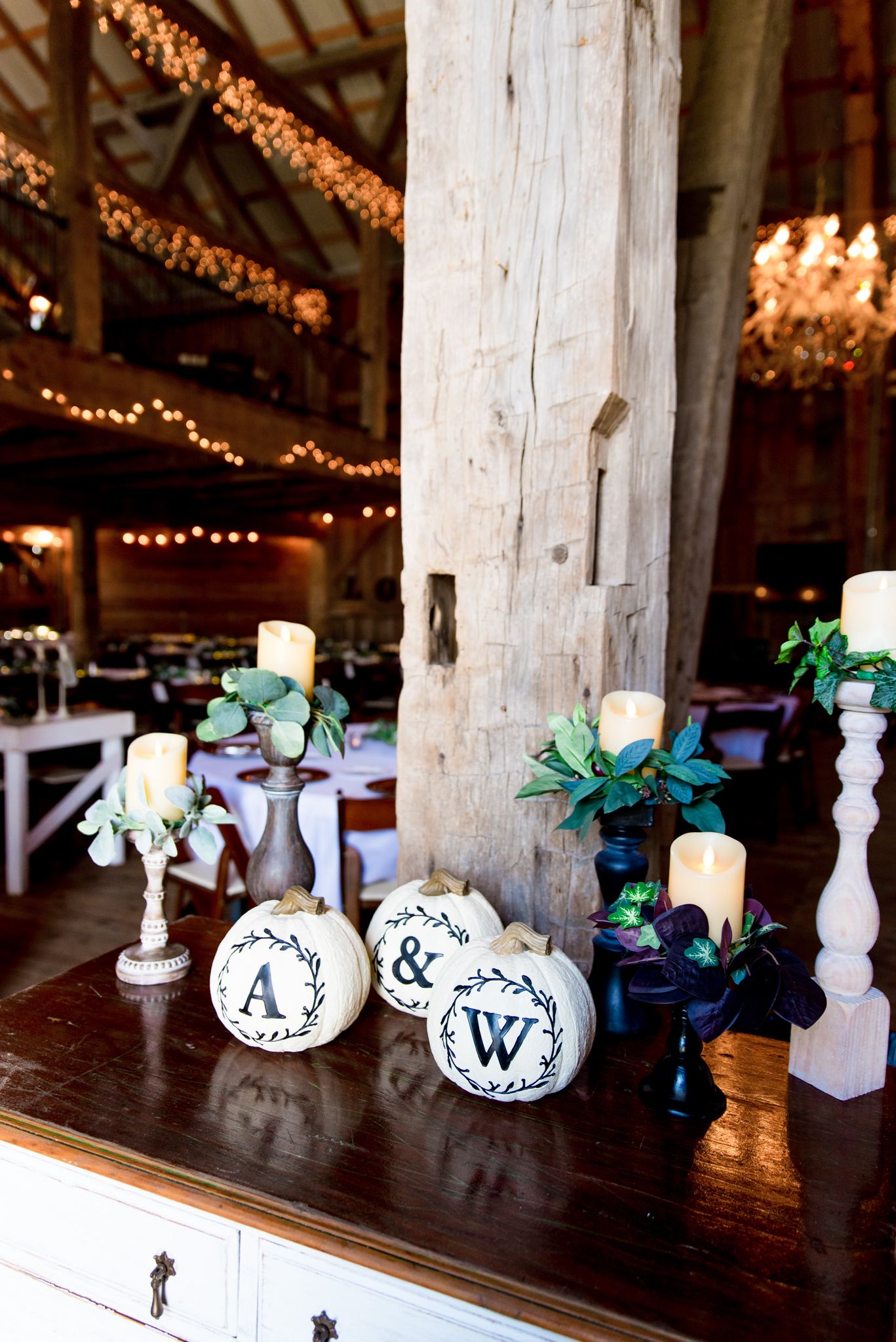 white pumpkins with A and W initials on them for the bride and groom's fall barn wedding in Ohio