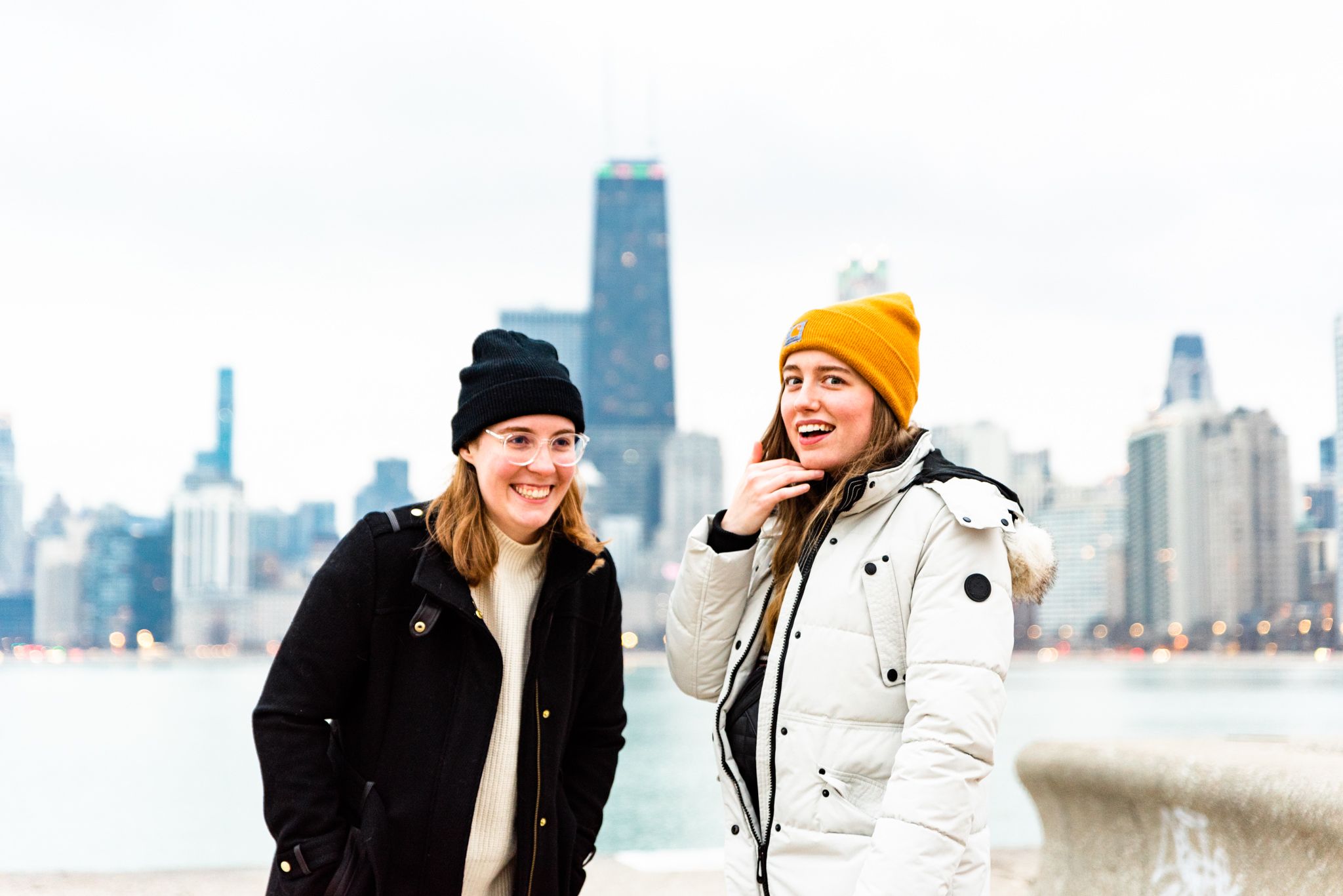 women looking shocked and happy after proposal at North Avenue Beach in Chicago