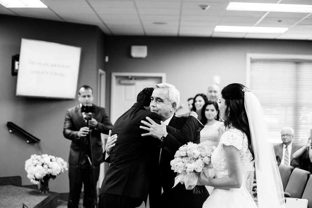 Bride's father hugs groom during Hudson Valley wedding ceremony