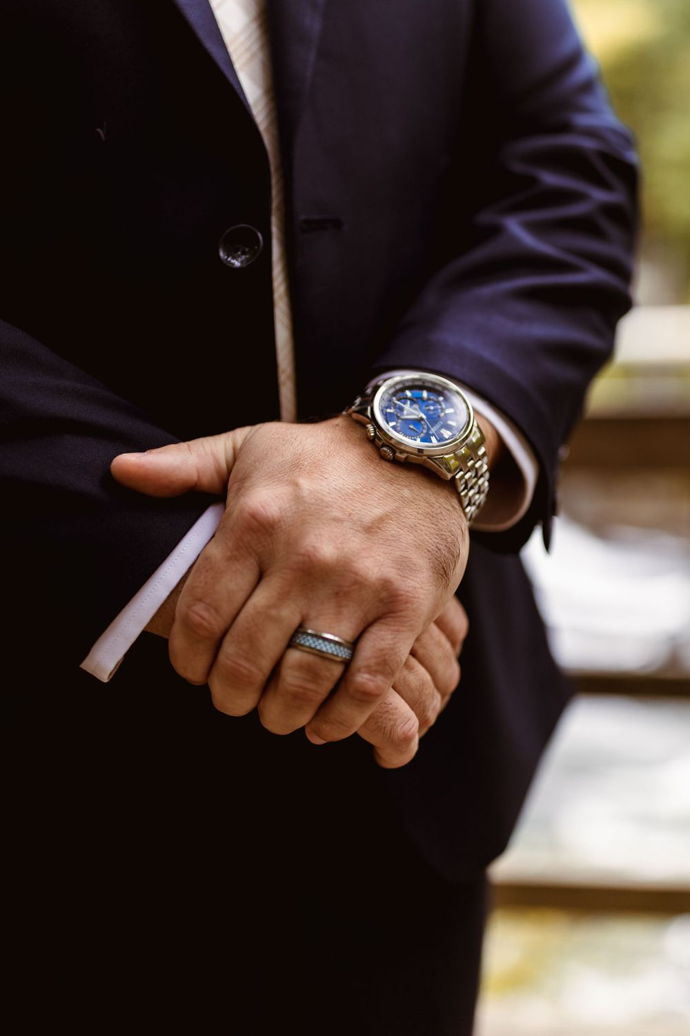 Close-up shots of groom's hands showing detailed watch and wedding attire.