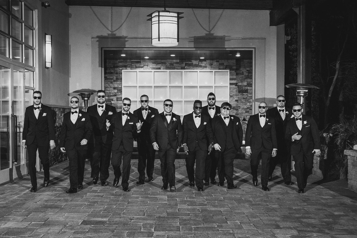 groomsman portrait walking at stone house