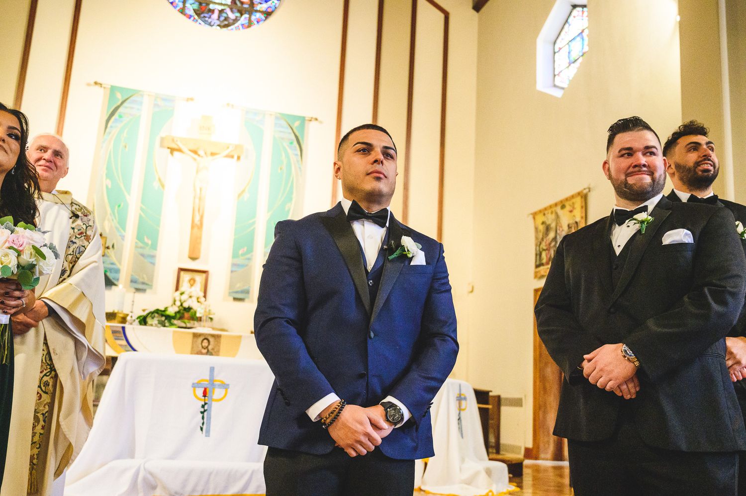 groom watching his bride come down the isle