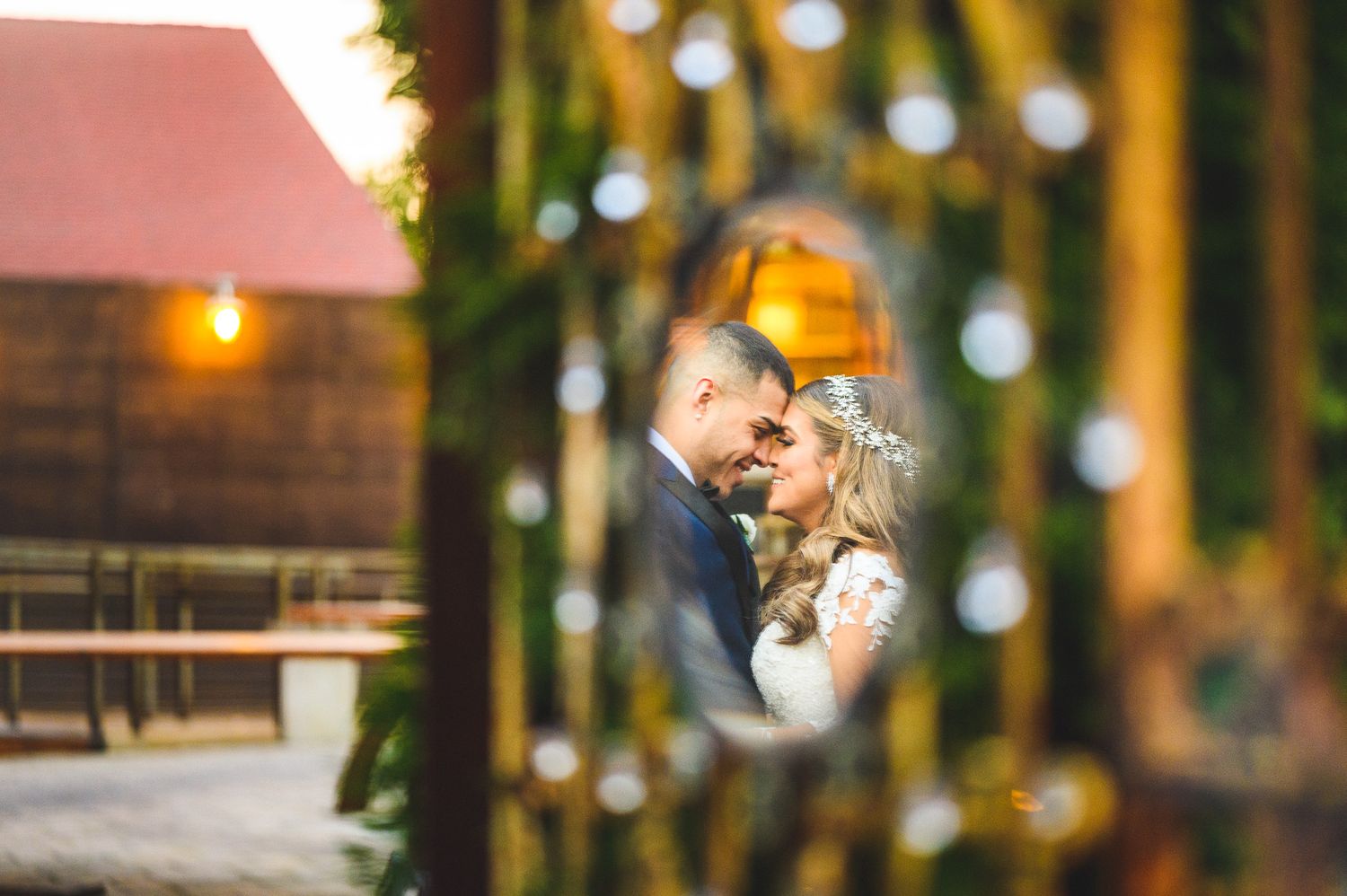 bride and groom hugging and smiling mirror reflection at stone house