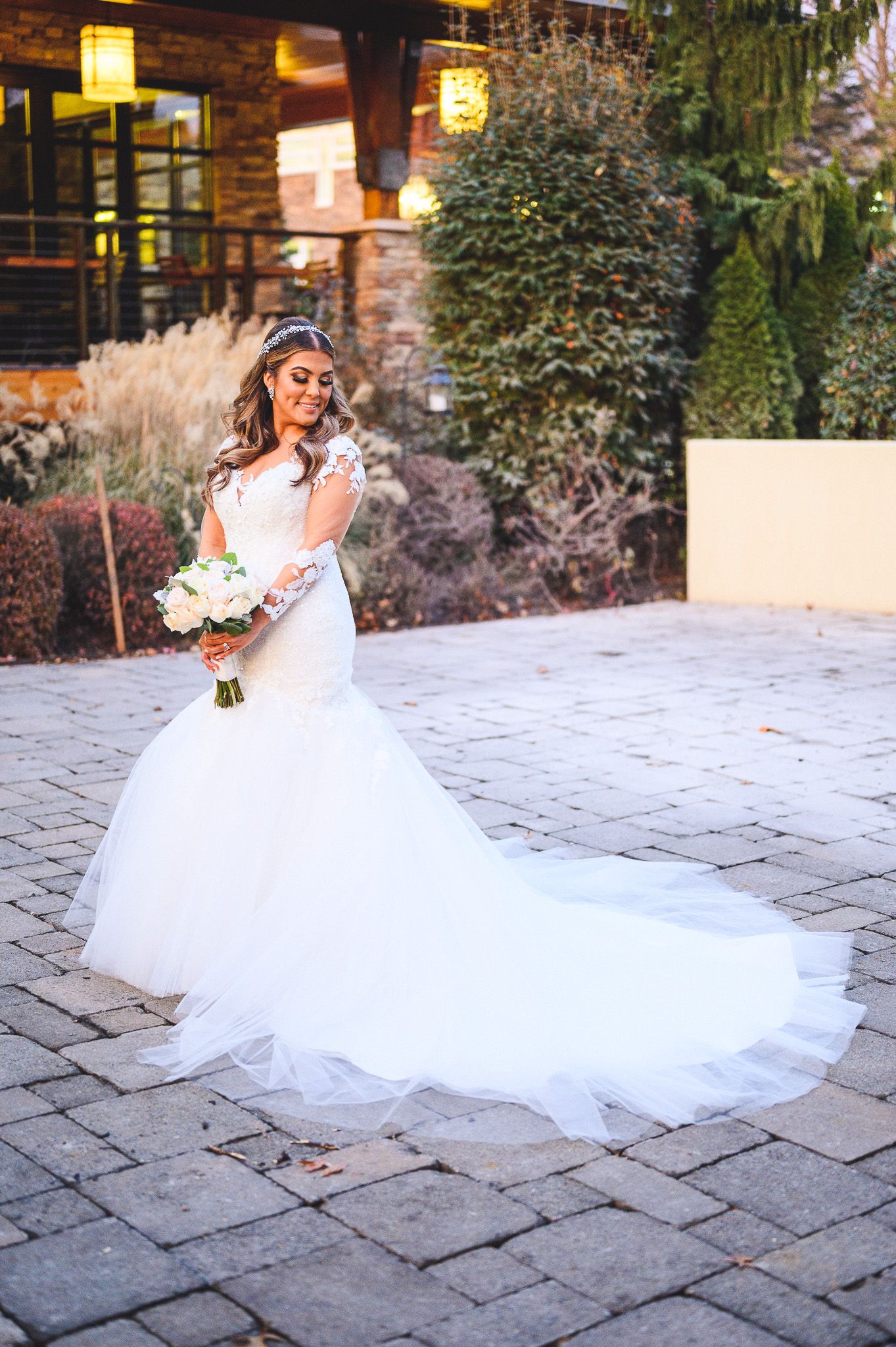 full length bridal portrait in white dress at stone house