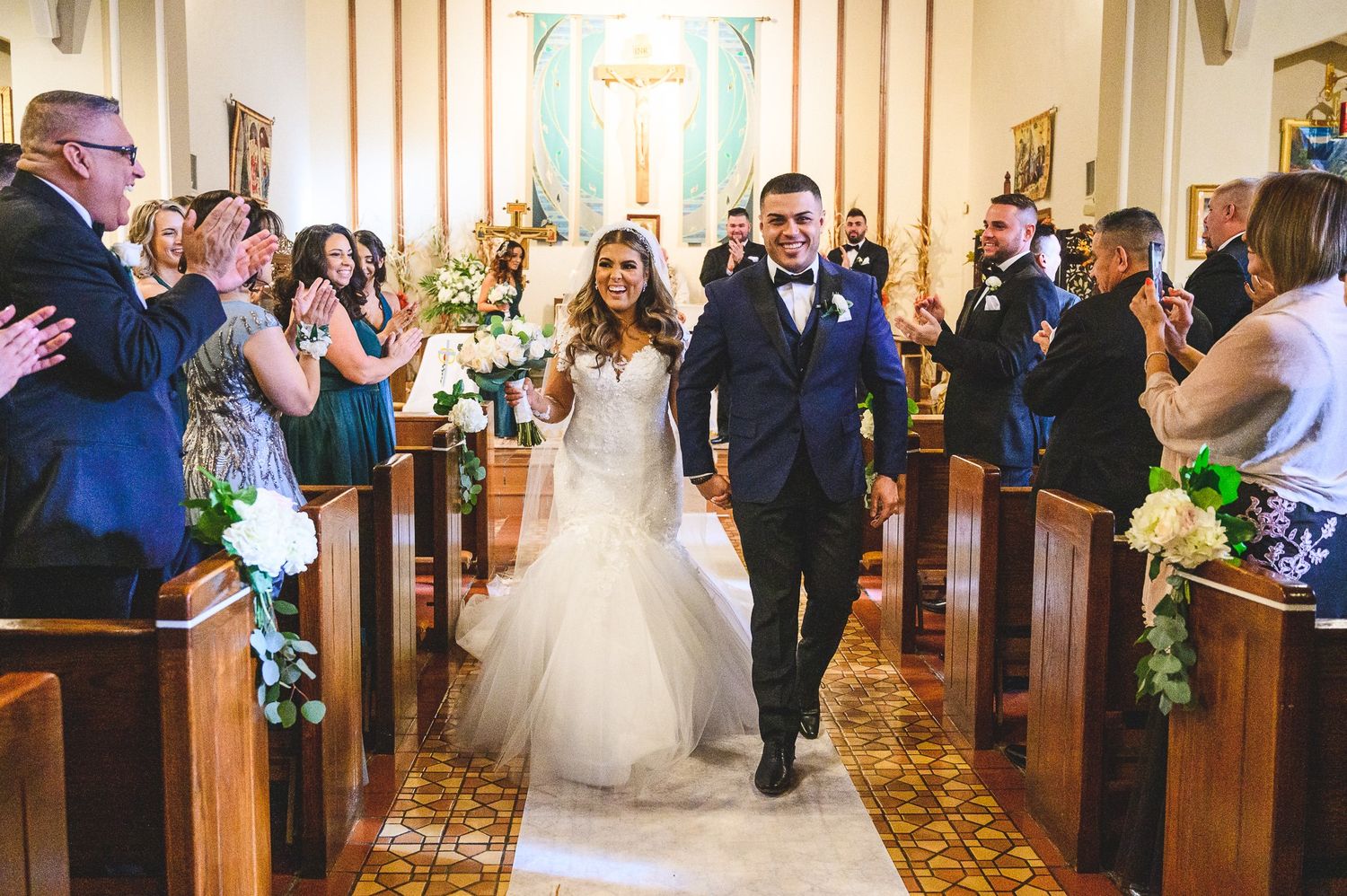bride and groom walking down isle after being married