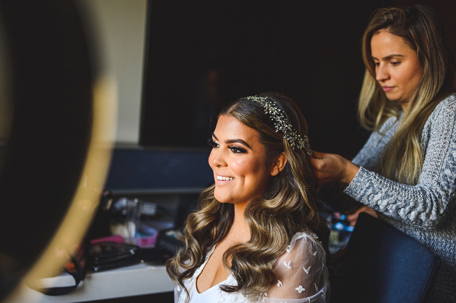 bride getting hair done during bride prep