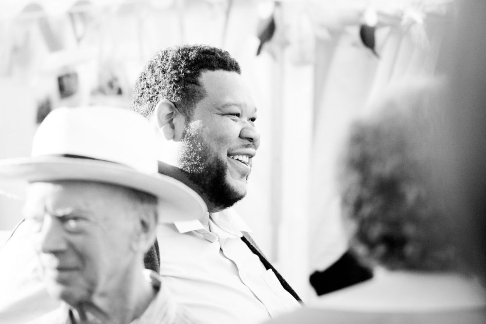 Man laughs at a joke in a crowd at a 50th birthday party - Event Photography