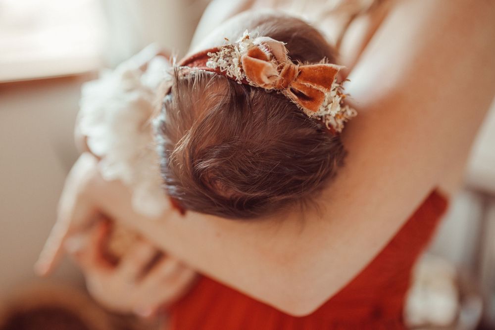 Delicate floral crown with dried flowers and pearls in warm sunlight.