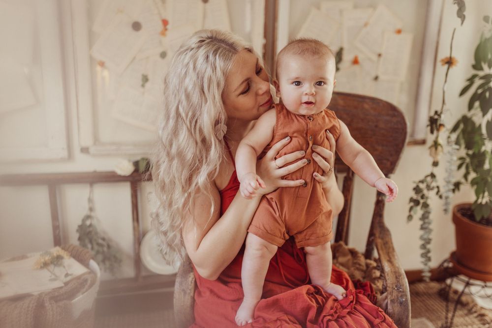 Tender moment captured in warm tones with baby in casual attire.