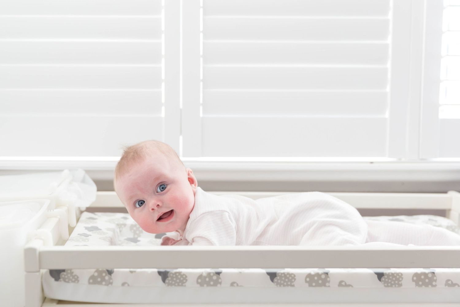 baby laying on changing table
