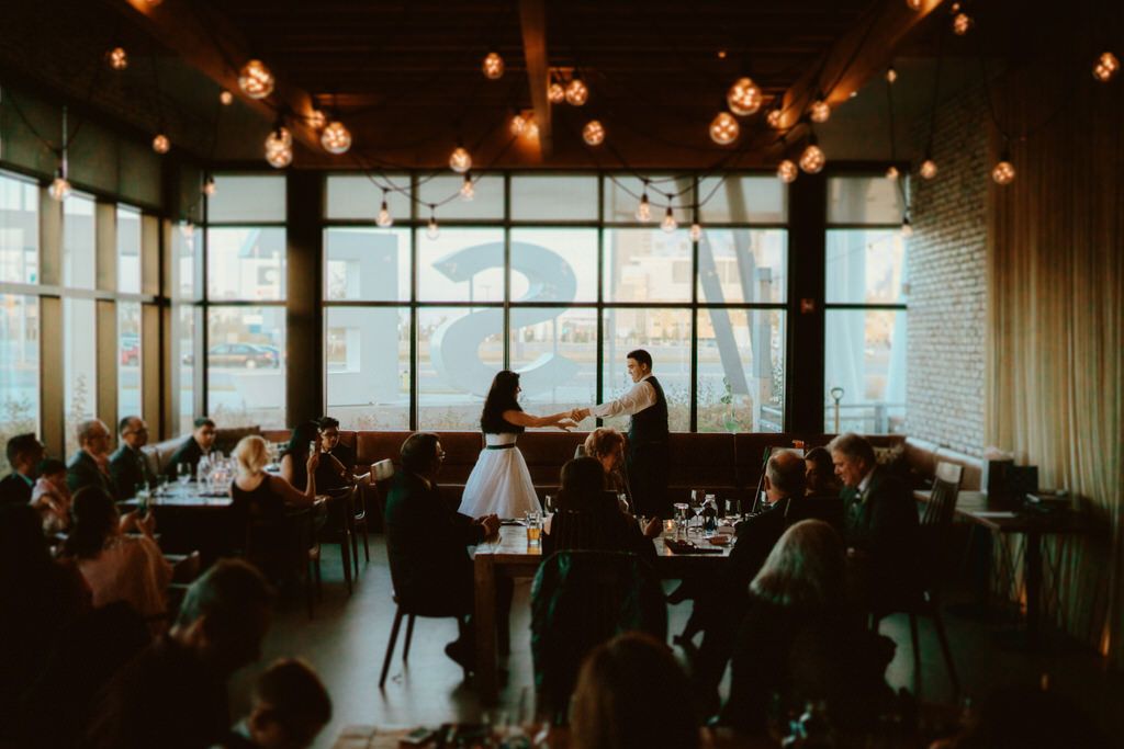 Indoor wedding reception venue with warm lighting and panoramic windows.