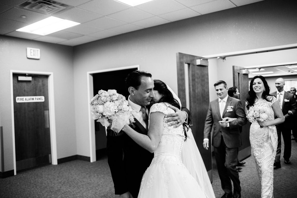 Bride and groom hug and cry after wedding ceremony