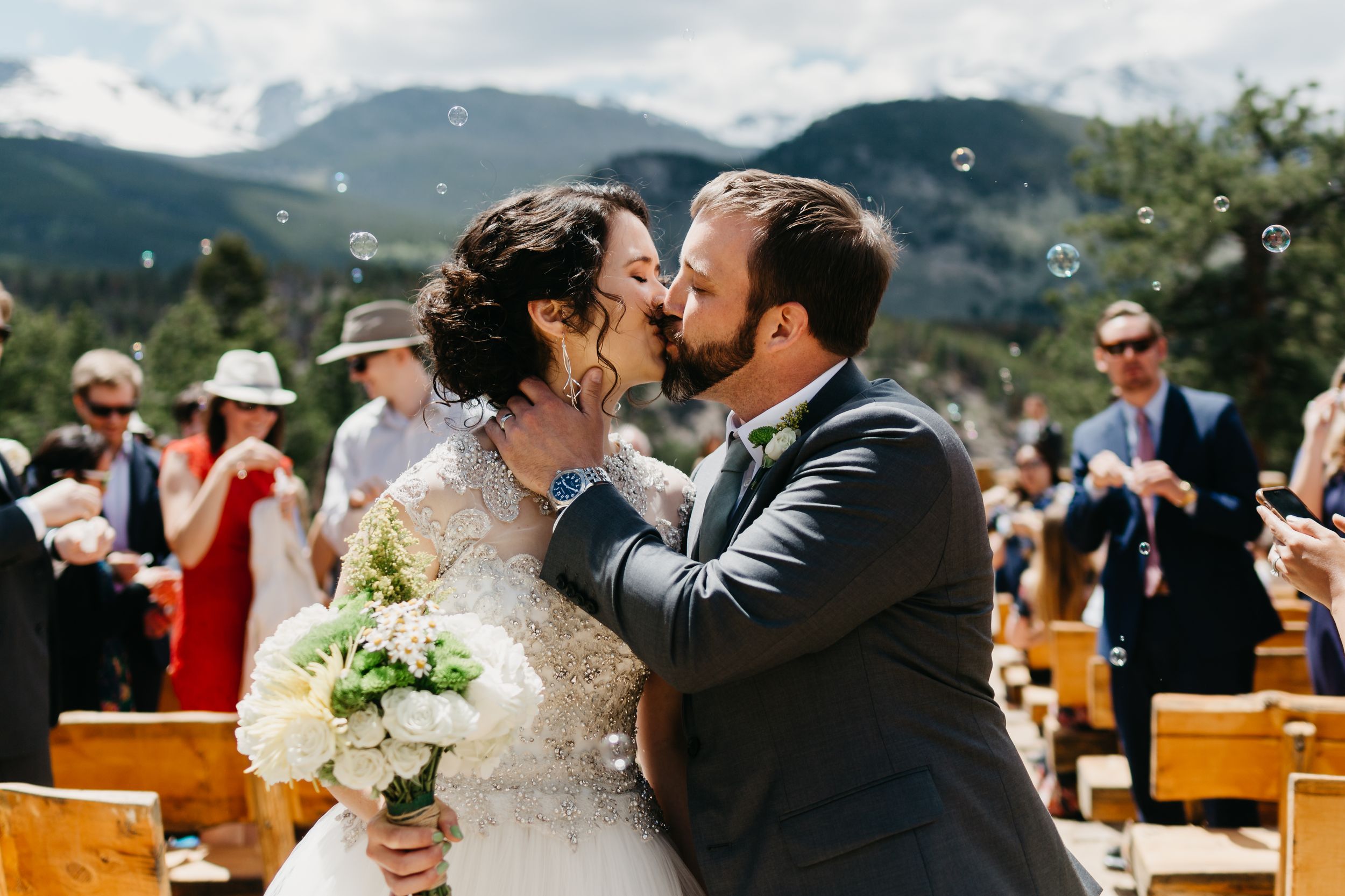 bride and groom, kiss, rmnp, ymca, ceremony, photography, colorado, estes park, forest wedding, classy, timeless