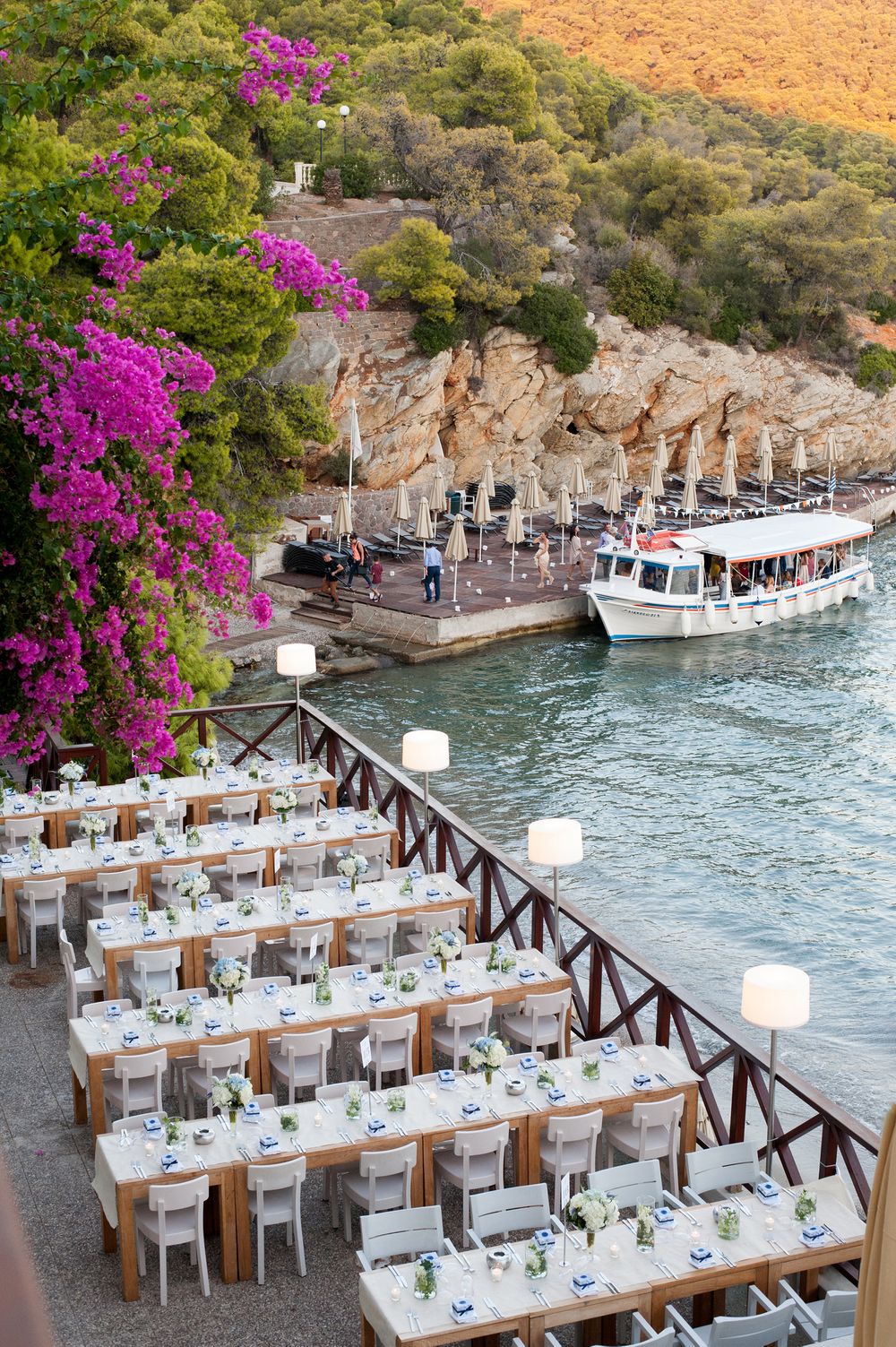 reception tables in white and light blue colors under a purple bumkavillia