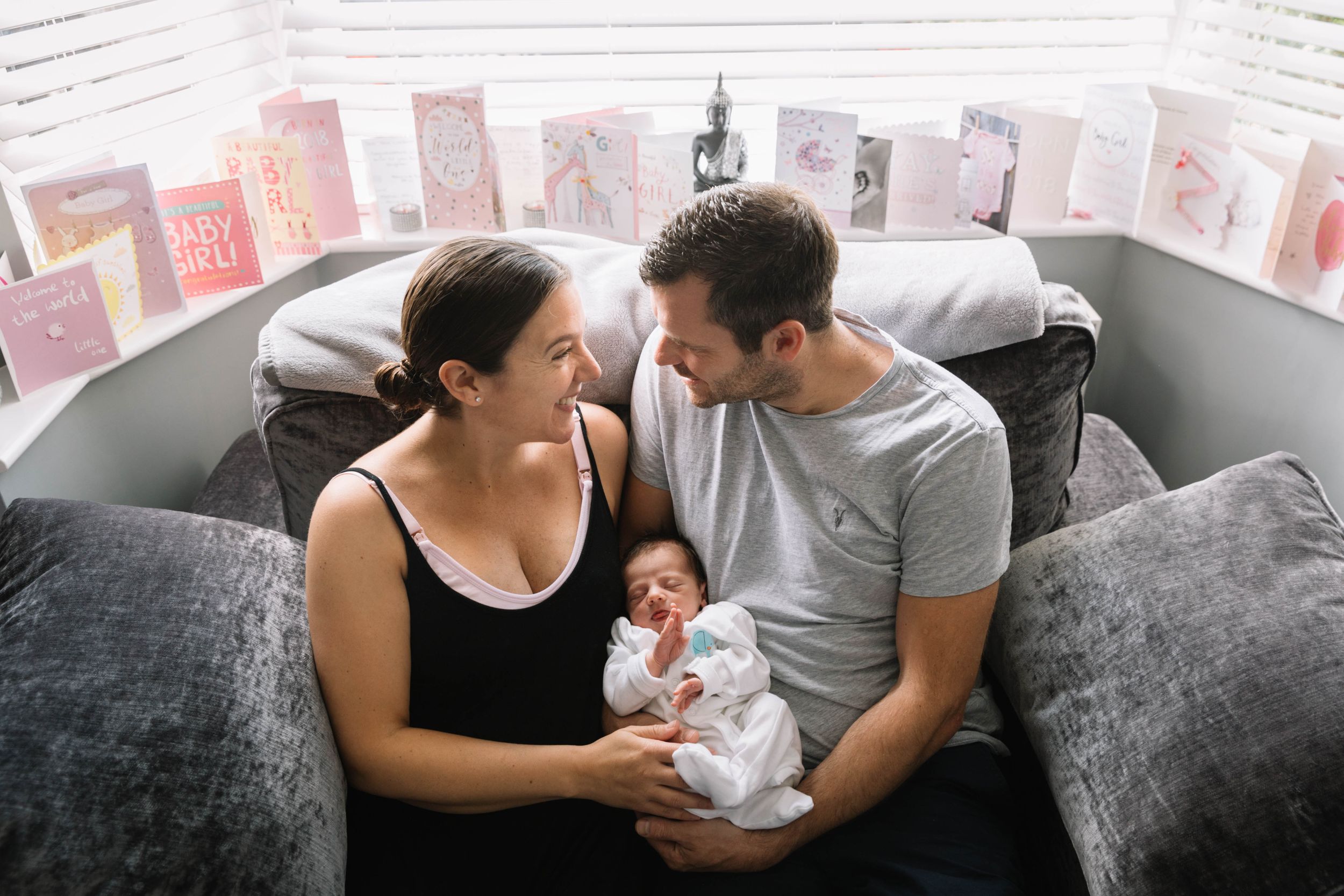2 week old newborn baby girl on sofa