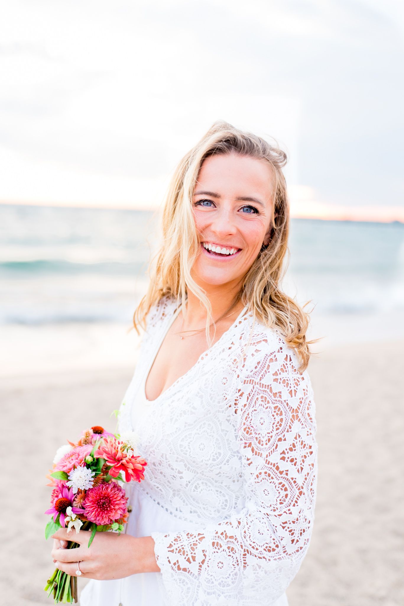 bride smiling on North Avenue Beach for Chicago sunrise engagement pictures