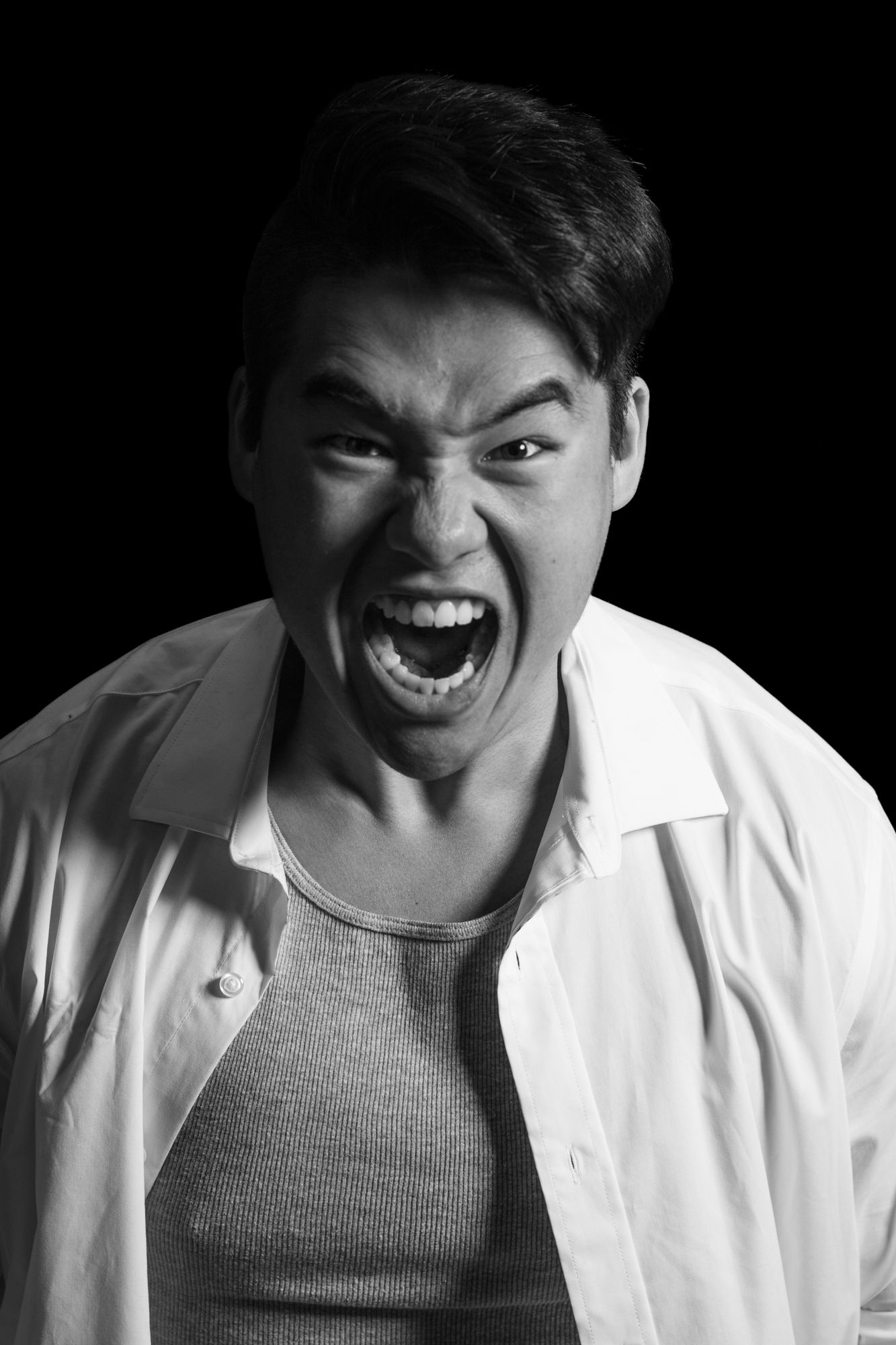 Dramatic black and white portrait showing intense emotional expression.