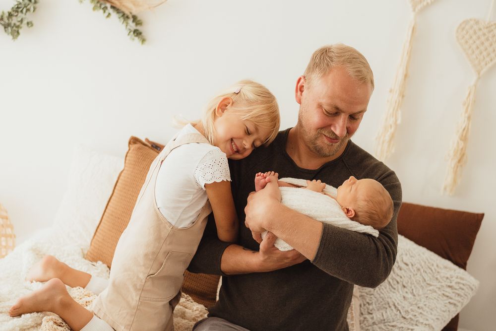 Papa und seine Kinder auf dem Bett Familienshooting