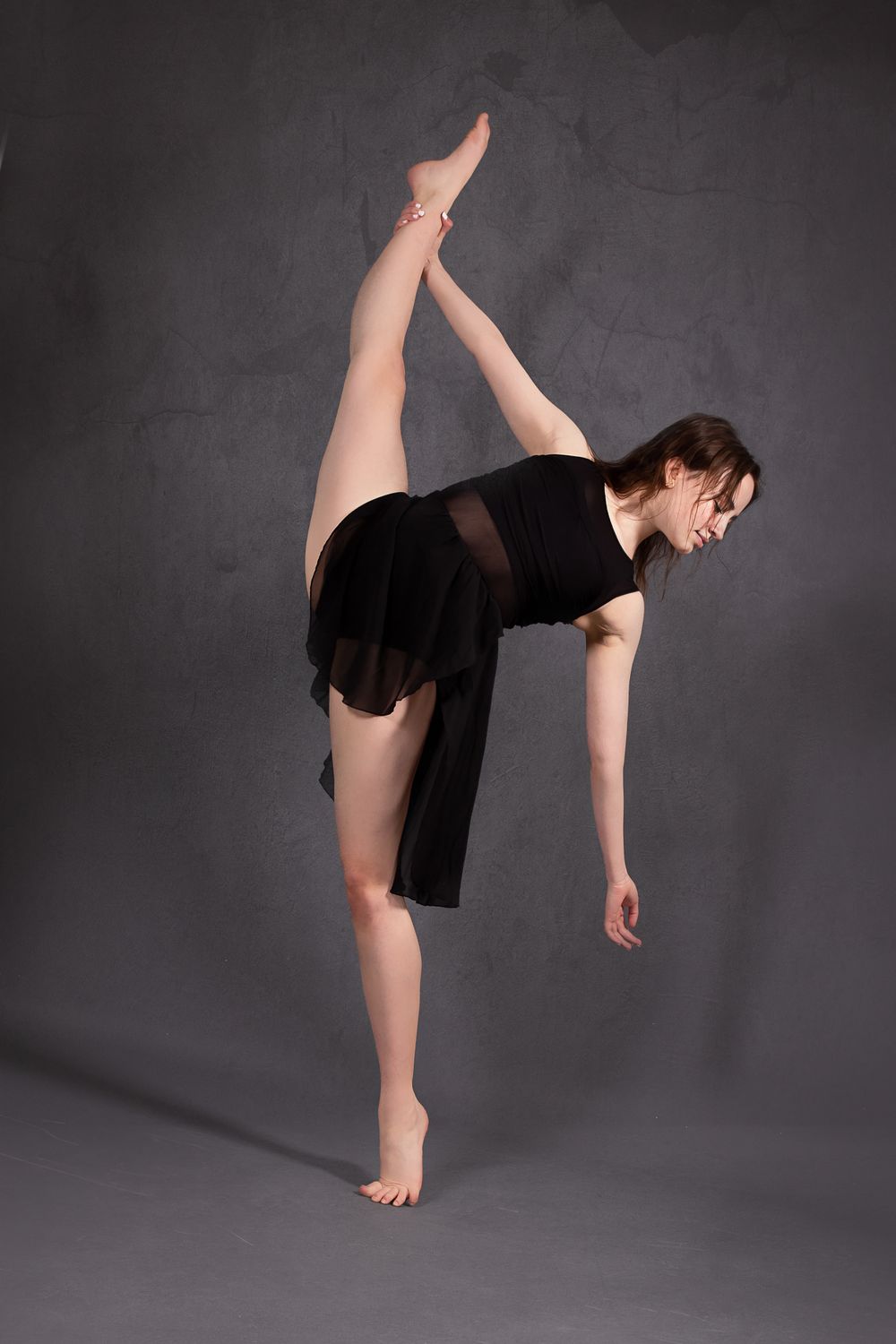 female dancer in leotard and skirt split hold