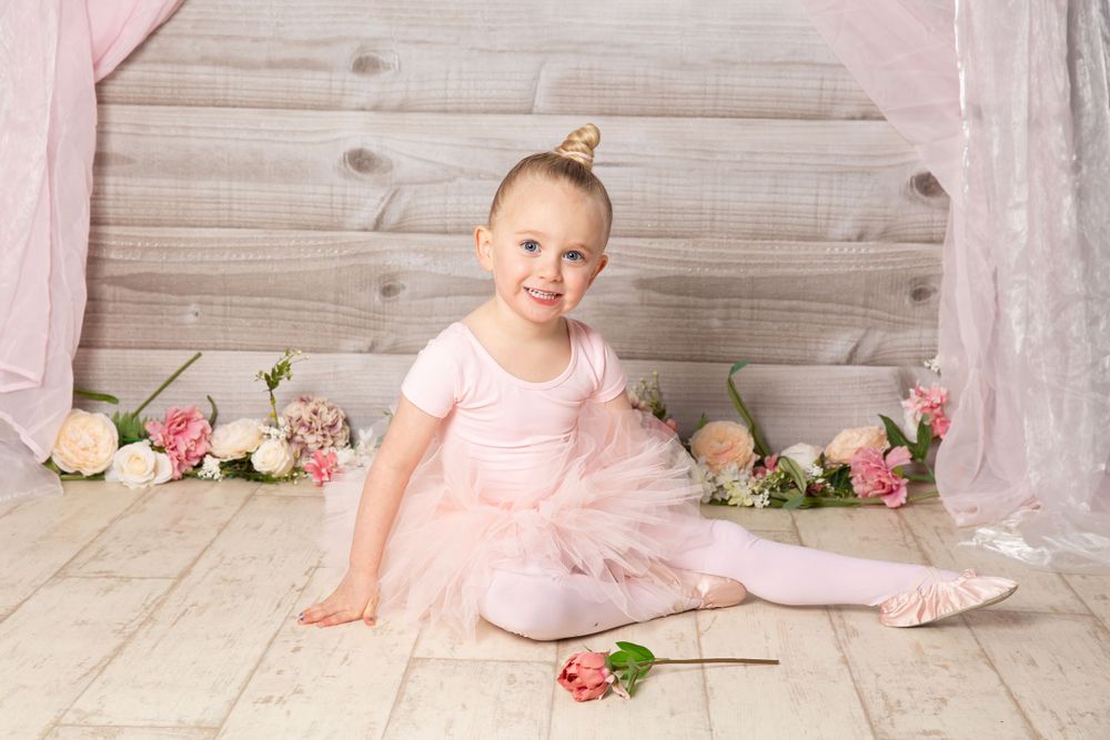 toddler baby ballet in pink sitting on floor
