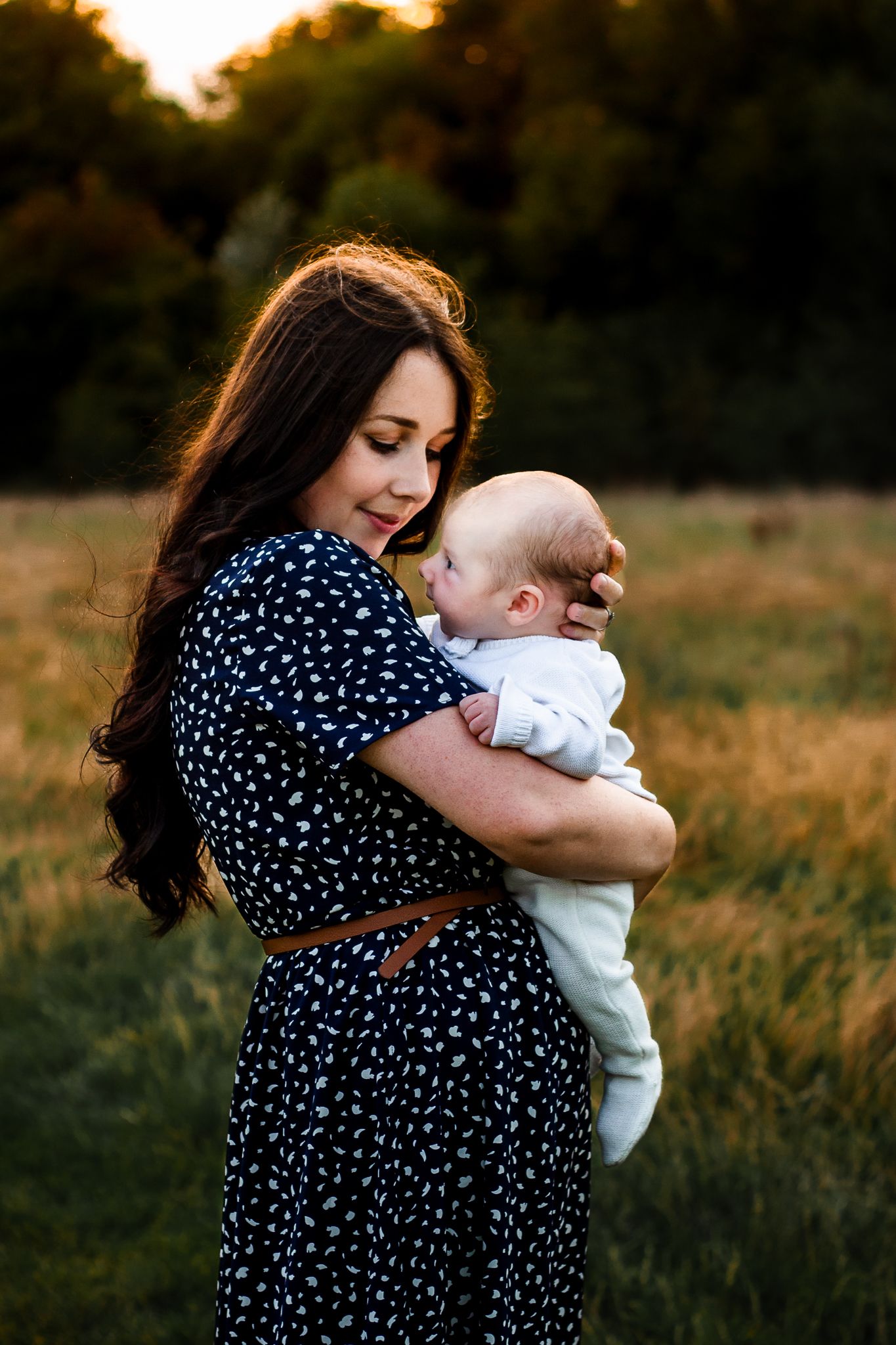 In a field in Havant, Hampshire a new Mum holds her Newborn Son close to her and smiles lovingly at him