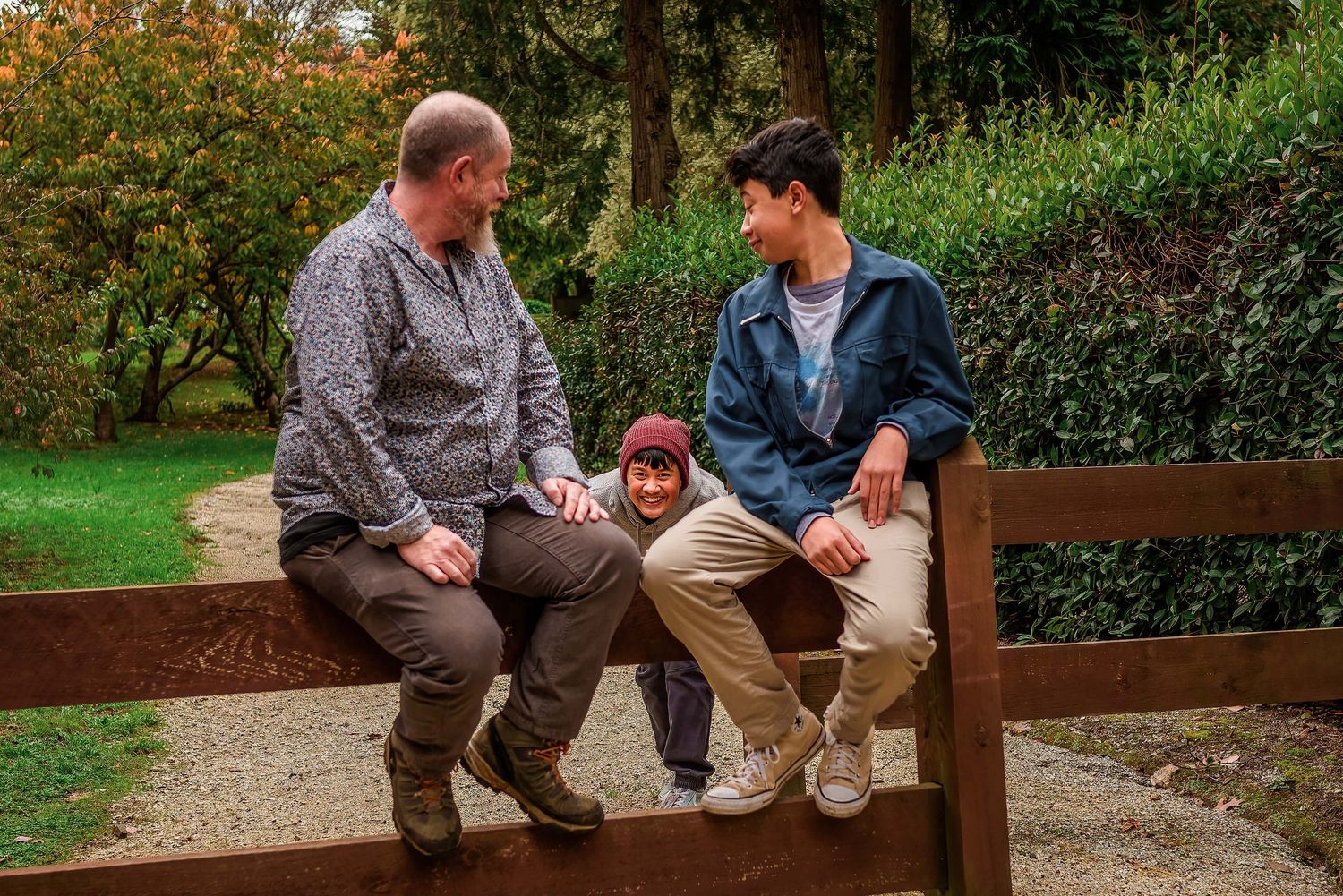 Youngest son sneaking up on his father and brother