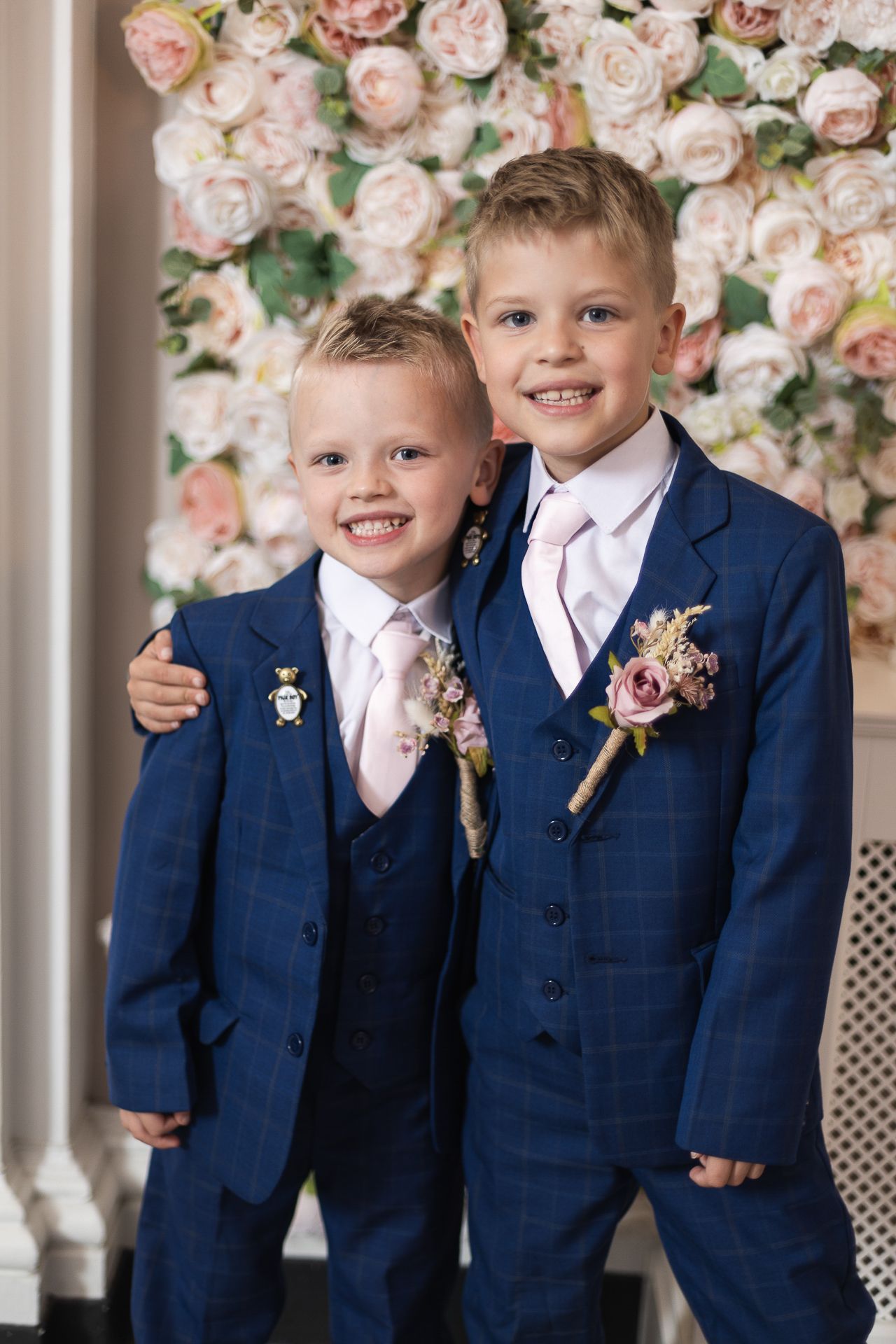 Page Boys in front of floral wall in waiting room of Chelsea Old Town Hall