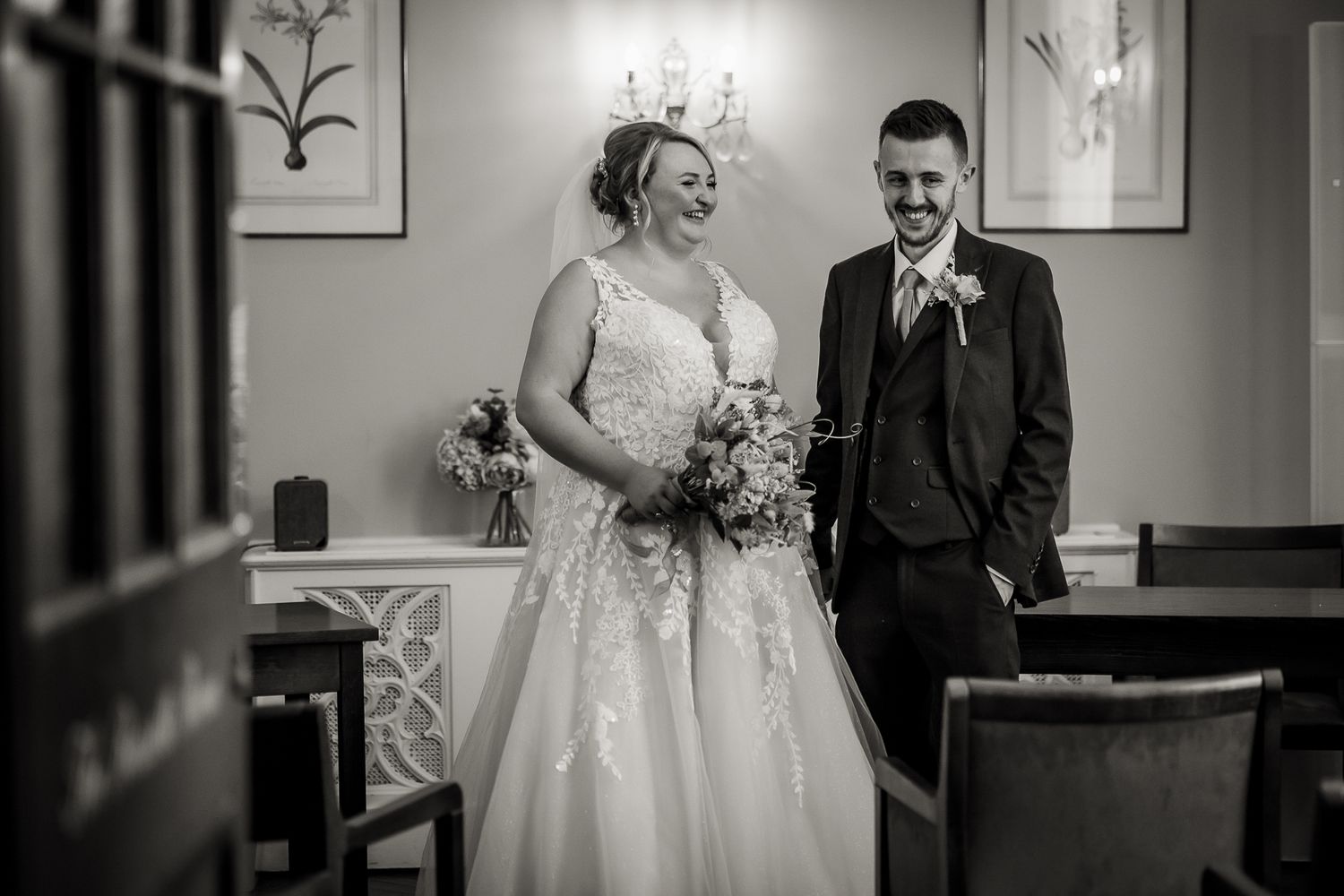 Black and white photography of newly wed bride and groom in Rossetti room, Chelsea London registry office.